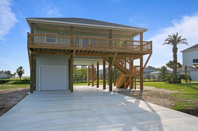 coastal home featuring board and batten siding, an attached garage, a carport, concrete driveway, and stairs