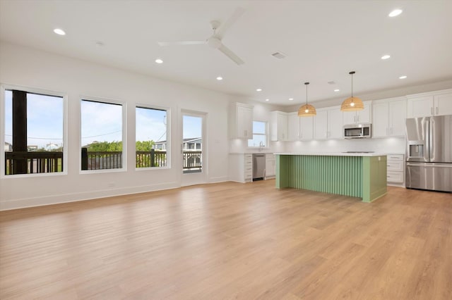 kitchen featuring white cabinetry, stainless steel appliances, light countertops, recessed lighting, and a ceiling fan