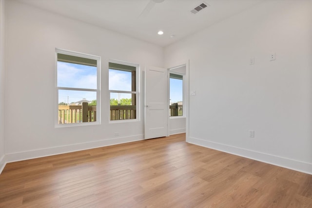 spare room with recessed lighting, visible vents, baseboards, and light wood-style floors