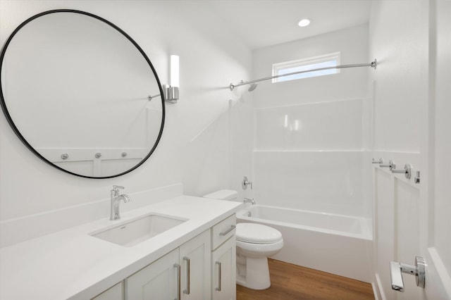bathroom featuring recessed lighting, wood finished floors, bathtub / shower combination, toilet, and vanity