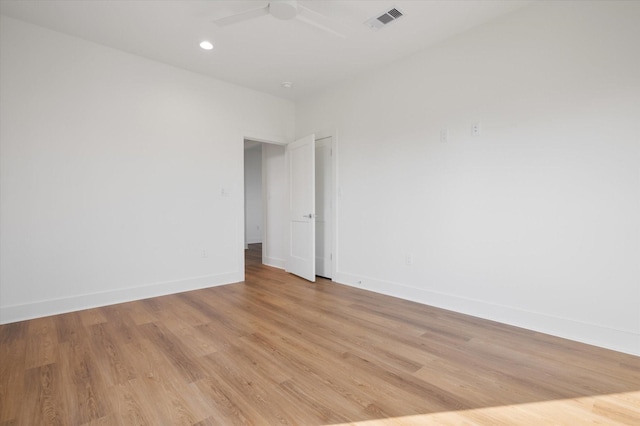 empty room featuring recessed lighting, a ceiling fan, visible vents, light wood-style flooring, and baseboards