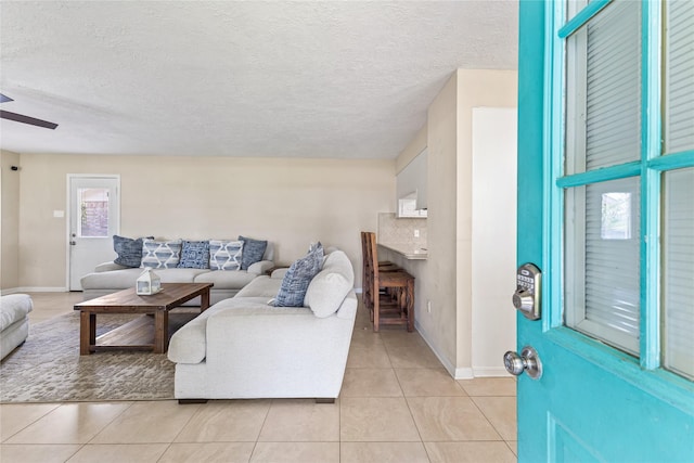 3358 County Road 172, Alvin, TX 77511 - living room with a ceiling fan, light tile patterned floors, baseboards, and a textured ceiling