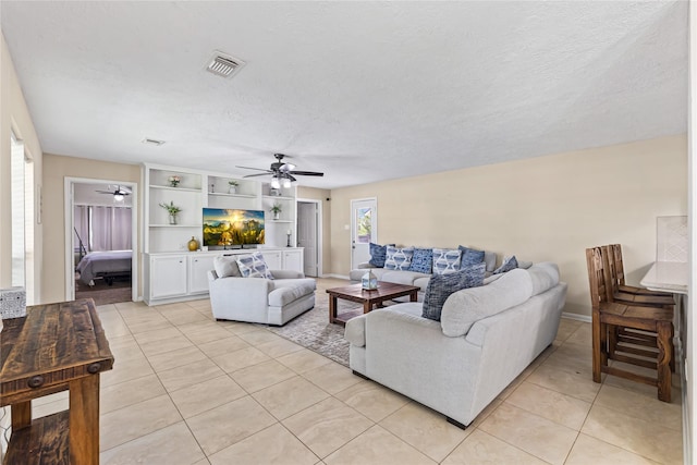 3358 County Road 172, Alvin, TX 77511 - living area with light tile patterned flooring, a textured ceiling, visible vents, baseboards, and ceiling fan