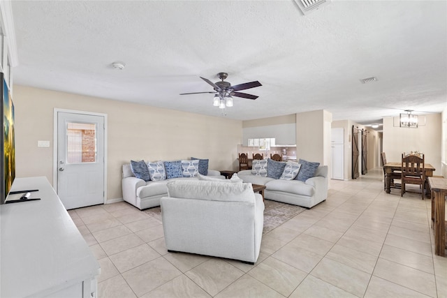 3358 County Road 172, Alvin, TX 77511 - living room with light tile patterned floors, a textured ceiling, visible vents, and ceiling fan with notable chandelier