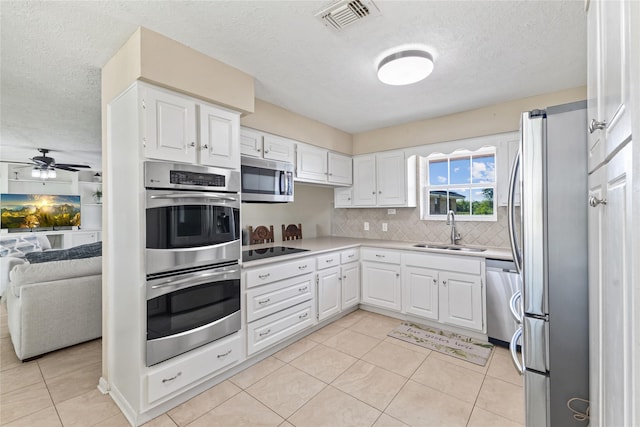 3358 County Road 172, Alvin, TX 77511 - kitchen featuring a sink, white cabinetry, open floor plan, stainless steel appliances, and visible vents