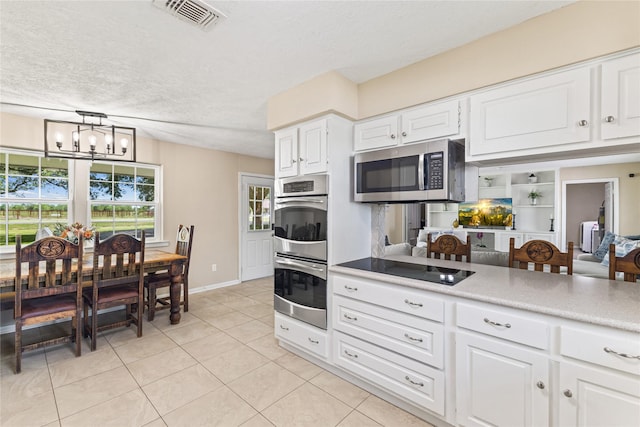 3358 County Road 172, Alvin, TX 77511 - kitchen featuring white cabinetry, light countertops, an inviting chandelier, visible vents, and appliances with stainless steel finishes