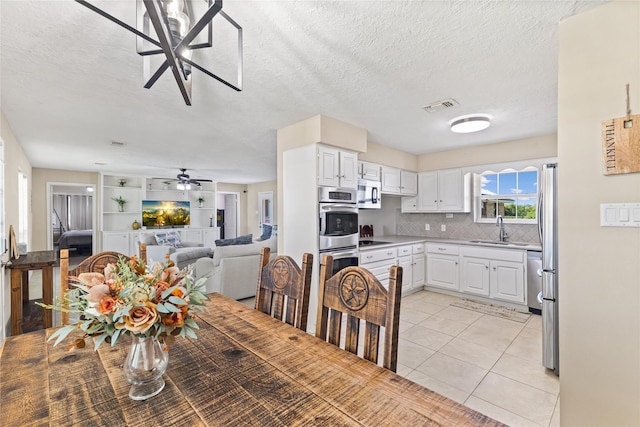 3358 County Road 172, Alvin, TX 77511 - interior space with appliances with stainless steel finishes, visible vents, white cabinets, and a sink