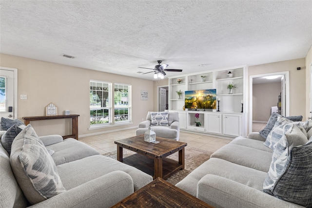 3358 County Road 172, Alvin, TX 77511 - living area with light tile patterned floors, baseboards, a textured ceiling, visible vents, and a ceiling fan
