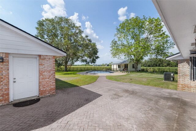 3358 County Road 172, Alvin, TX 77511 - view of yard with fence, a patio, a fenced in pool, central AC, and an outdoor structure