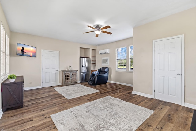 3358 County Road 172, Alvin, TX 77511 - sitting room with baseboards, a wall unit AC, wood finished floors, and a ceiling fan