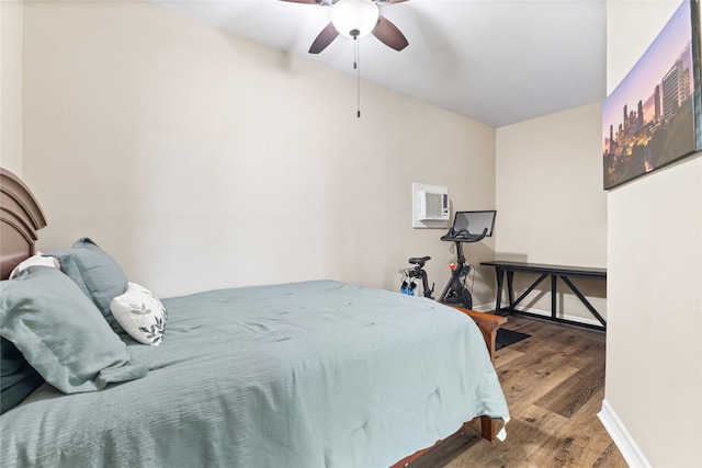 3358 County Road 172, Alvin, TX 77511 - bedroom with an AC wall unit, baseboards, ceiling fan, and wood finished floors