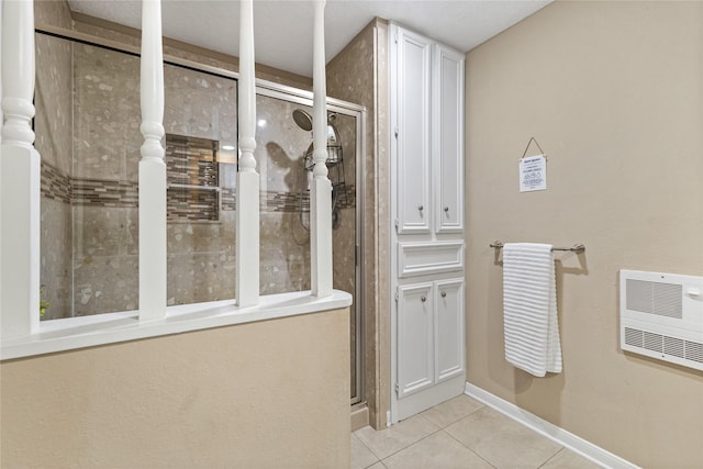 3358 County Road 172, Alvin, TX 77511 - full bathroom featuring heating unit, tile patterned floors, a stall shower, and baseboards