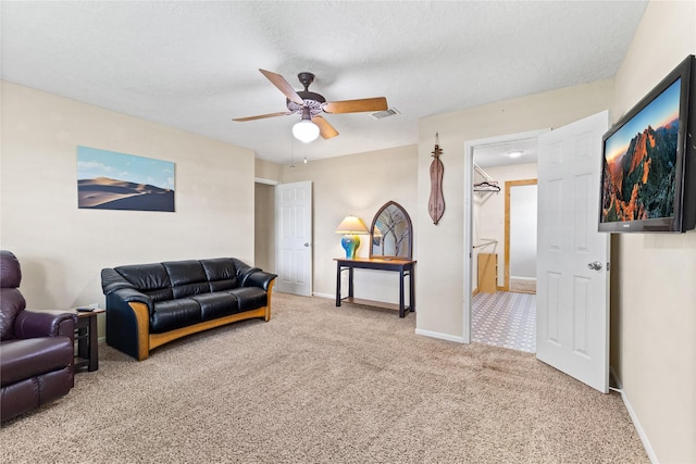 3358 County Road 172, Alvin, TX 77511 - living area featuring a textured ceiling, baseboards, visible vents, ceiling fan, and carpet