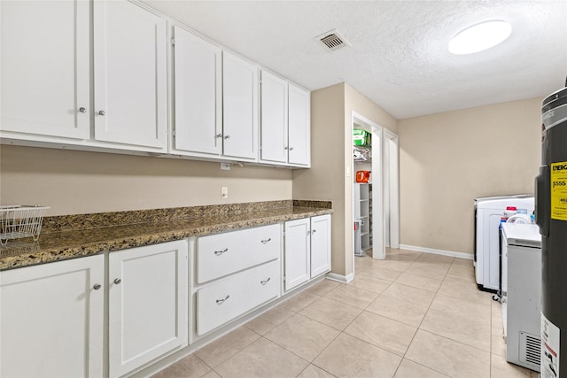 3358 County Road 172, Alvin, TX 77511 - kitchen featuring light tile patterned flooring, a textured ceiling, washer / clothes dryer, visible vents, and white cabinets