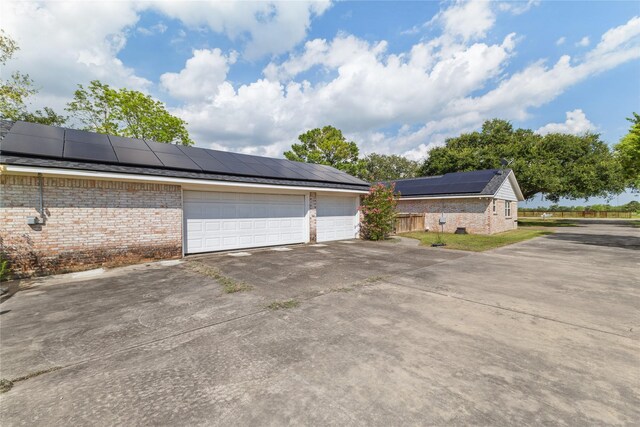 3358 County Road 172, Alvin, TX 77511 - garage with roof mounted solar panels and fence