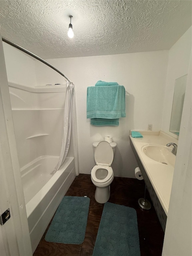 bathroom with a textured ceiling, toilet, shower / bath combination with curtain, wood finished floors, and vanity