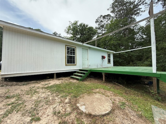 rear view of house featuring a deck