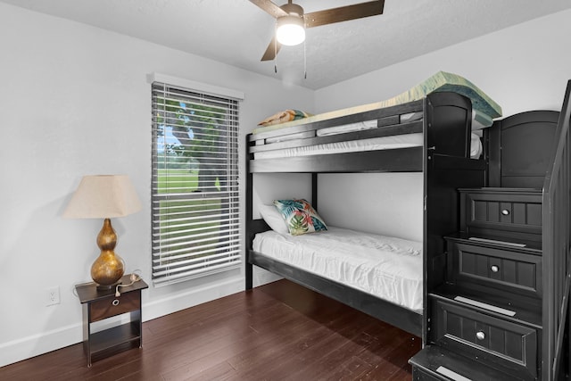 bedroom featuring ceiling fan, wood finished floors, and baseboards