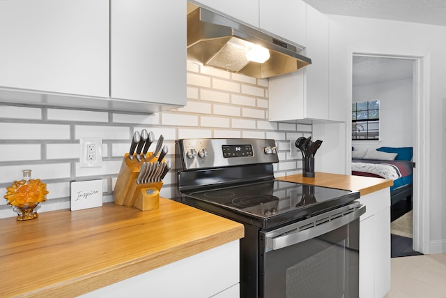 kitchen featuring white cabinetry, electric stove, and under cabinet range hood