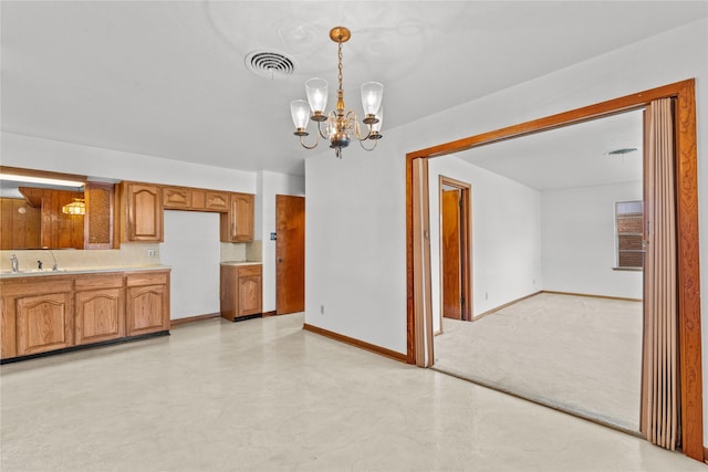 1403 Marlock Ln, Pasadena, TX 77502 - kitchen featuring a chandelier, brown cabinets, light countertops, baseboards, and hanging light fixtures