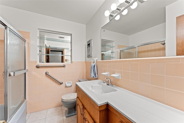 1403 Marlock Ln, Pasadena, TX 77502 - full bath featuring tile walls, tile patterned floors, toilet, shower / bath combination with glass door, and vanity