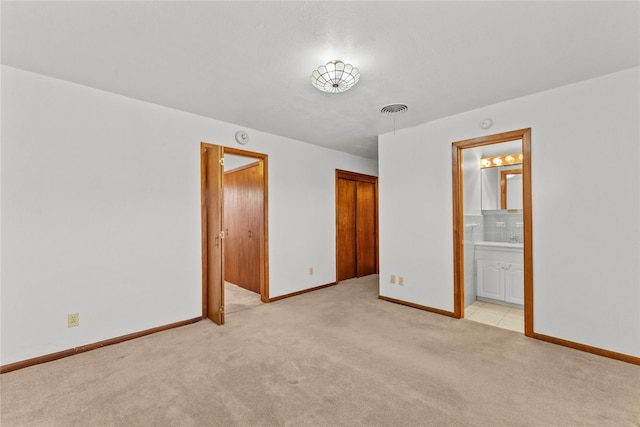 1403 Marlock Ln, Pasadena, TX 77502 - unfurnished bedroom with light carpet, ensuite bathroom, and baseboards
