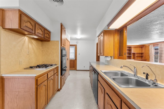 1403 Marlock Ln, Pasadena, TX 77502 - kitchen featuring a sink, black appliances, healthy amount of natural light, and light countertops