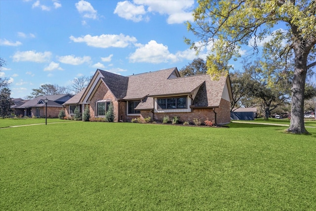 18602 Carriage Ct, Houston, TX 77058 - tudor-style house with brick siding, a front yard, and roof with shingles