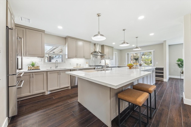 18602 Carriage Ct, Houston, TX 77058 - kitchen with wall chimney exhaust hood, a sink, dark wood-style flooring, a center island with sink, and recessed lighting