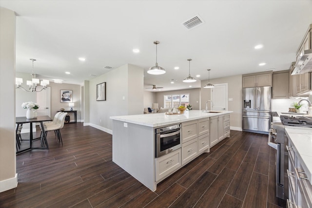 18602 Carriage Ct, Houston, TX 77058 - kitchen with high end appliances, dark wood-type flooring, baseboards, and recessed lighting
