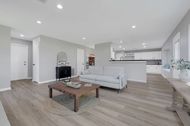 1410 Wesley Ln, Deer Park, TX 77536 - living area featuring recessed lighting, light wood-type flooring, and baseboards