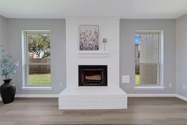 1410 Wesley Ln, Deer Park, TX 77536 - unfurnished living room with a fireplace, wood finished floors, and baseboards