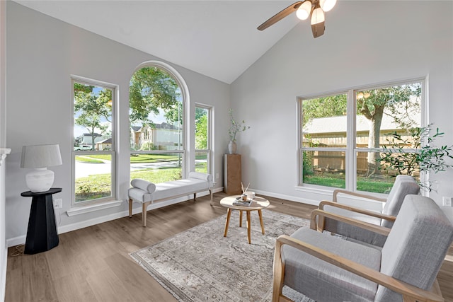 1410 Wesley Ln, Deer Park, TX 77536 - living area featuring healthy amount of natural light, a ceiling fan, high vaulted ceiling, wood finished floors, and baseboards