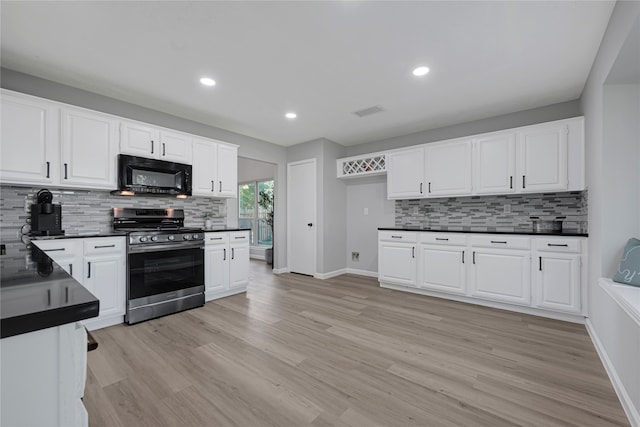 1410 Wesley Ln, Deer Park, TX 77536 - kitchen with gas stove, black microwave, dark countertops, tasteful backsplash, and recessed lighting