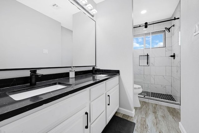 1410 Wesley Ln, Deer Park, TX 77536 - bathroom featuring toilet, a shower stall, wood finished floors, double vanity, and baseboards