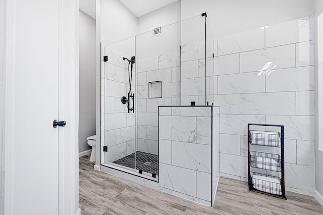 1410 Wesley Ln, Deer Park, TX 77536 - bathroom featuring walk in shower, toilet, wood finished floors, and baseboards