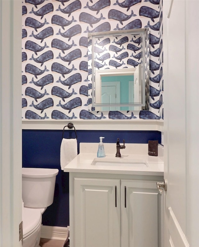 2627 Holiday Dr, Port Bolivar, TX 77650 - bathroom featuring baseboards, toilet, and vanity