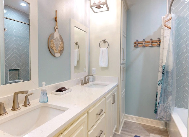 2627 Holiday Dr, Port Bolivar, TX 77650 - full bath featuring baseboards, double vanity, a sink, and wood finished floors