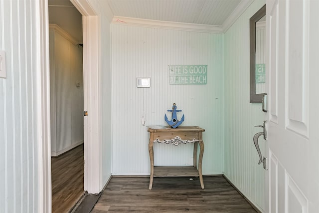 foyer entrance with dark wood-style floors and ornamental molding