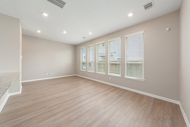 210 Fulton Station Dr, Houston, TX 77009 - unfurnished living room with visible vents, baseboards, recessed lighting, and light wood-style floors
