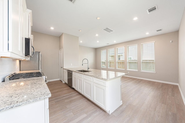 210 Fulton Station Dr, Houston, TX 77009 - kitchen featuring light wood-style flooring, visible vents, appliances with stainless steel finishes, a sink, and baseboards