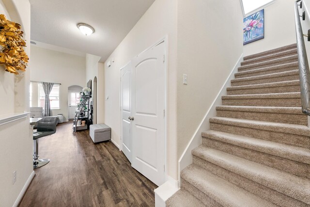 13754 Evansdale Ln, Houston, TX 77083 - stairway featuring wood finished floors, arched walkways, and baseboards