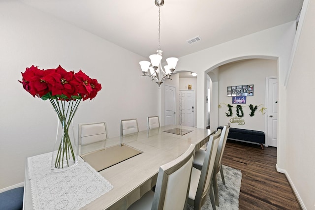 13754 Evansdale Ln, Houston, TX 77083 - dining room with arched walkways, a chandelier, dark wood-style floors, and baseboards