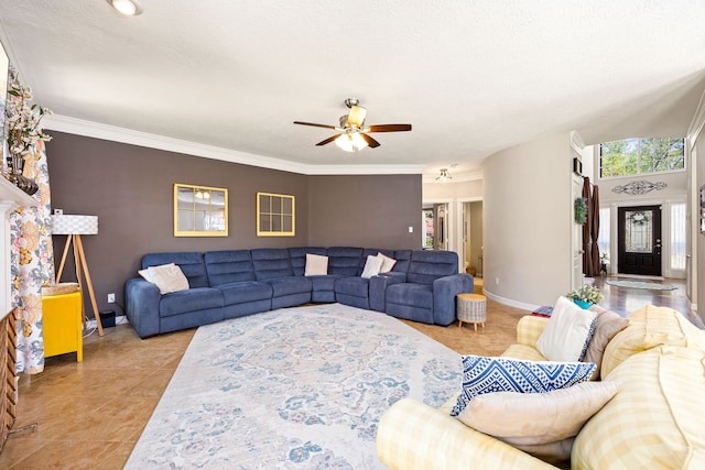 living room featuring ornamental molding, baseboards, ceiling fan, and light tile patterned floors