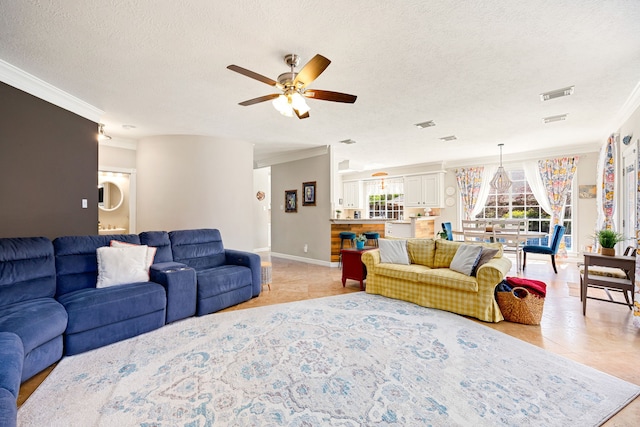 living room featuring a textured ceiling, crown molding, and a ceiling fan