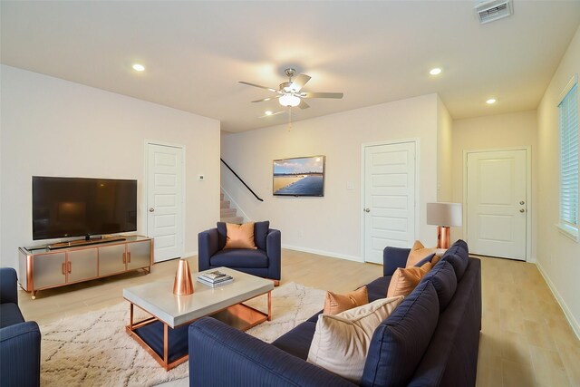 living area featuring recessed lighting, visible vents, stairway, and a ceiling fan