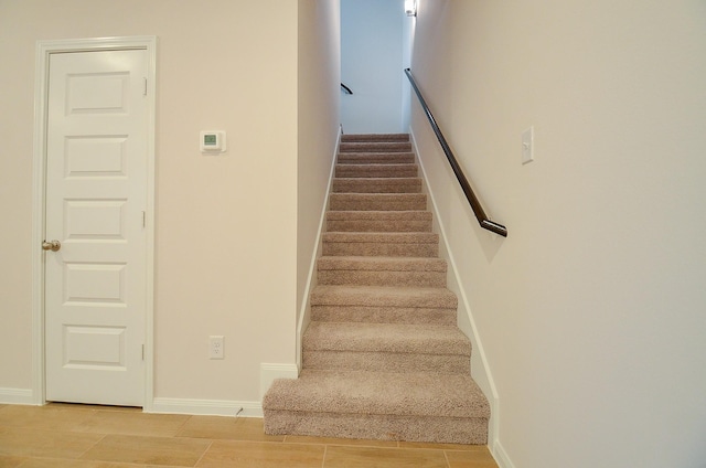 stairway with baseboards and wood finish floors