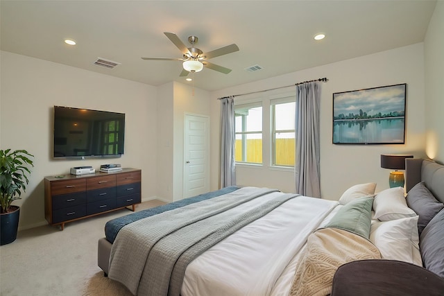 bedroom featuring baseboards, light colored carpet, and visible vents