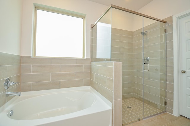 full bath featuring a shower stall and a garden tub