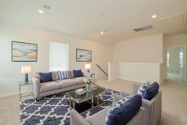 carpeted living area featuring lofted ceiling, visible vents, recessed lighting, and attic access
